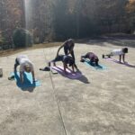 Outdoor yoga practice among autumn trees